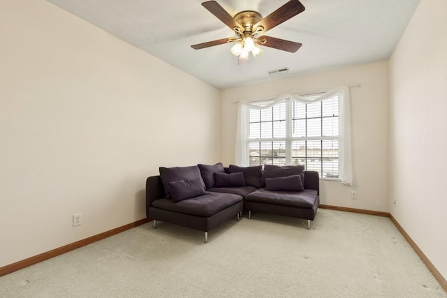 living room featuring vaulted ceiling, light carpet, and ceiling fan