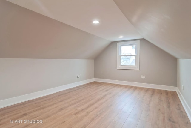 bonus room with lofted ceiling and light hardwood / wood-style flooring