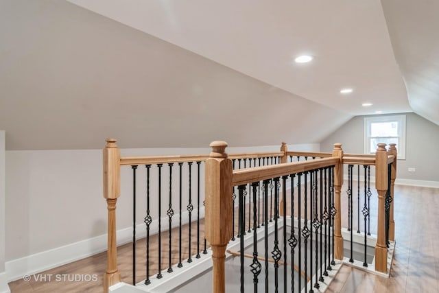 additional living space with lofted ceiling and hardwood / wood-style floors