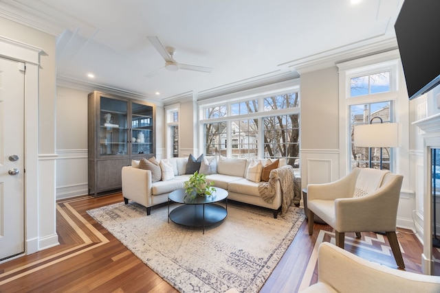 living room with crown molding, ceiling fan, dark hardwood / wood-style flooring, and a wealth of natural light