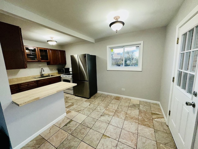 kitchen with appliances with stainless steel finishes, kitchen peninsula, and sink