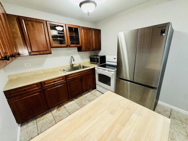 kitchen with sink and appliances with stainless steel finishes