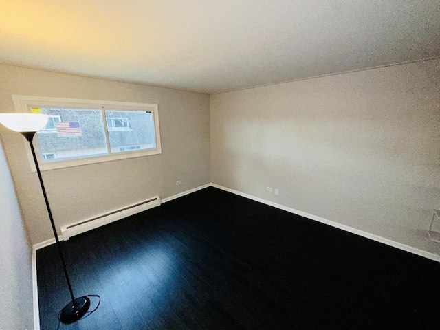 unfurnished room with hardwood / wood-style flooring and a baseboard radiator