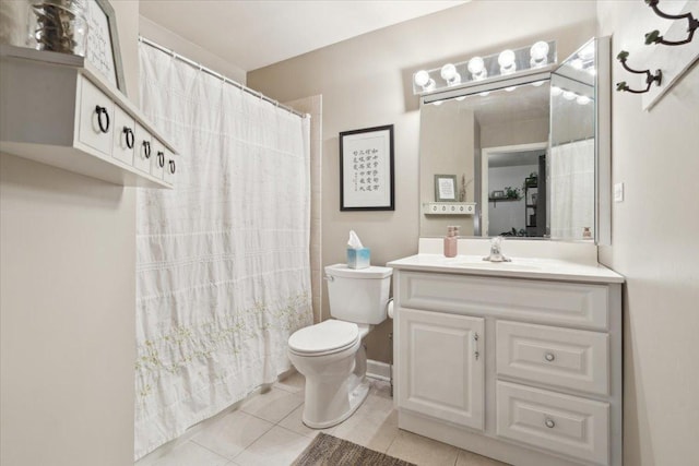 bathroom featuring tile patterned flooring, vanity, and toilet