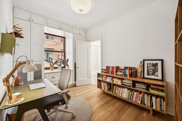 home office featuring light hardwood / wood-style flooring and ornamental molding