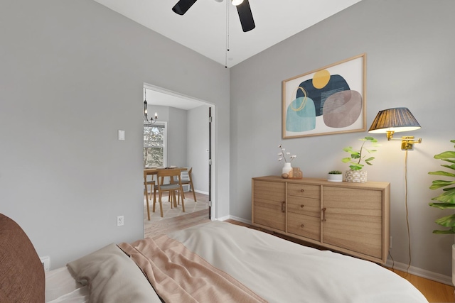 bedroom with light hardwood / wood-style flooring and a chandelier