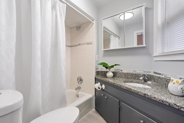 full bathroom with vanity, shower / bath combo, and toilet