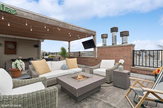 view of patio featuring an outdoor living space with a fire pit