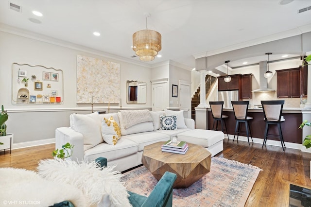 living room featuring crown molding, decorative columns, and dark hardwood / wood-style floors