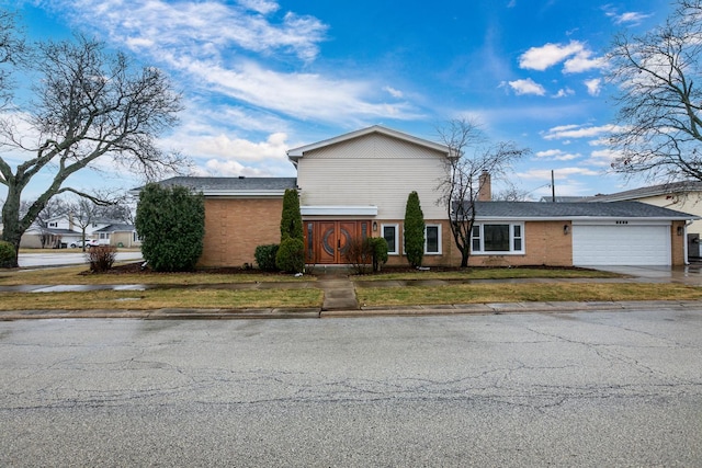 view of front of home featuring a garage and a front lawn