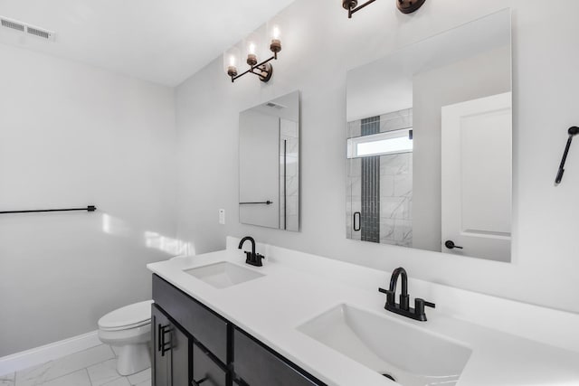 bathroom with vanity, toilet, and an enclosed shower