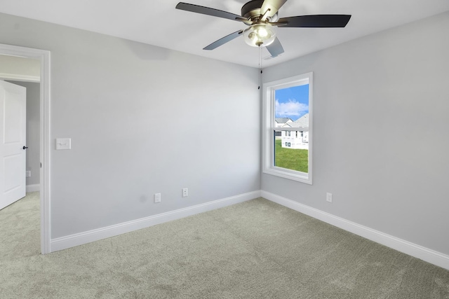 carpeted empty room featuring ceiling fan