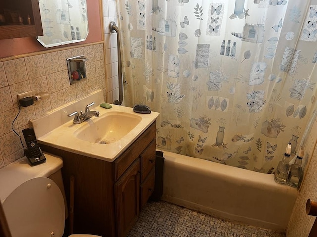 full bathroom featuring toilet, vanity, shower / bathtub combination with curtain, and tile walls