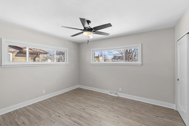 unfurnished bedroom with ceiling fan, light hardwood / wood-style floors, and a closet