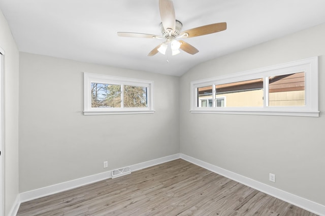 unfurnished room featuring ceiling fan, vaulted ceiling, and light hardwood / wood-style floors