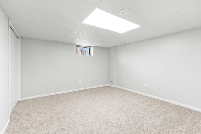 basement with carpet flooring and a drop ceiling