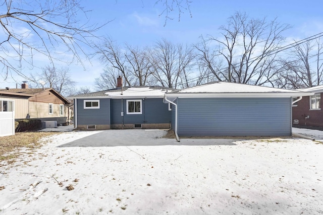 view of snow covered rear of property