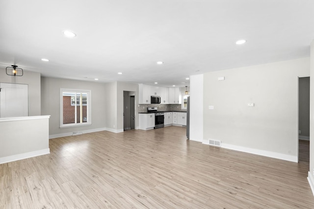 unfurnished living room with light wood-type flooring