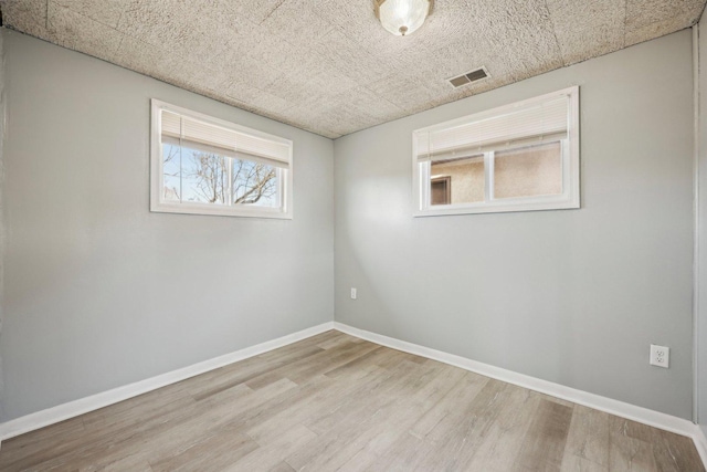 unfurnished room with light hardwood / wood-style flooring