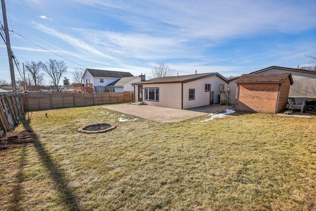 rear view of property featuring a lawn and a patio area