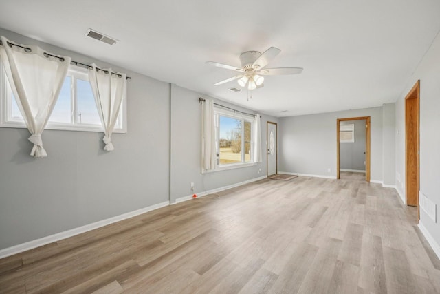 spare room featuring ceiling fan and light wood-type flooring