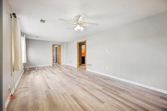 empty room featuring ceiling fan and light wood-type flooring