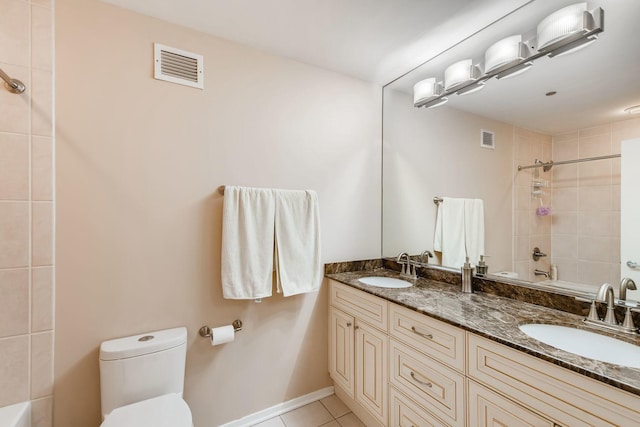 full bathroom with vanity, tiled shower / bath, tile patterned floors, and toilet