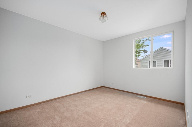 unfurnished room with light colored carpet