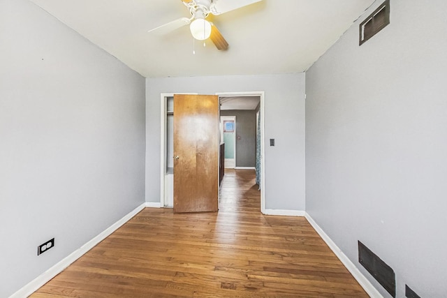 unfurnished room with hardwood / wood-style floors and ceiling fan