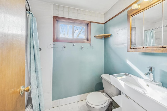 bathroom featuring vanity, a shower with shower curtain, tile patterned floors, and toilet