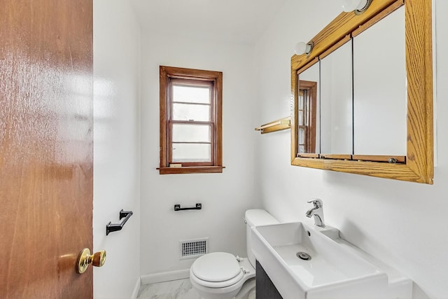 bathroom featuring toilet and sink