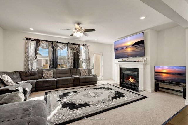 carpeted living room featuring ceiling fan