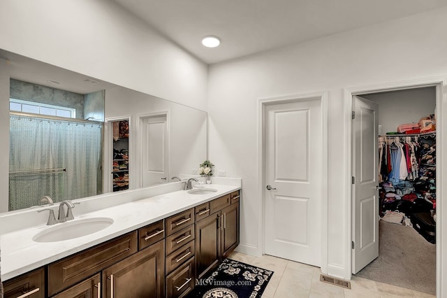 bathroom with tile patterned flooring, vanity, and a shower with shower curtain