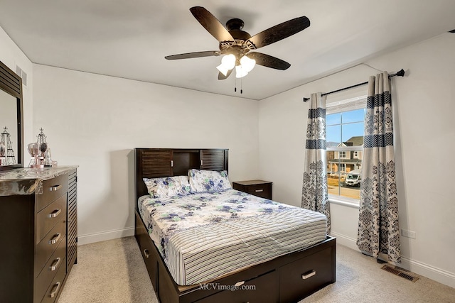 bedroom with light carpet and ceiling fan