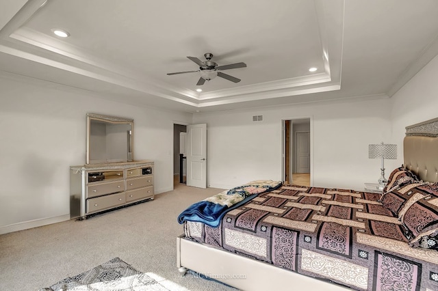 carpeted bedroom with crown molding, ceiling fan, and a tray ceiling