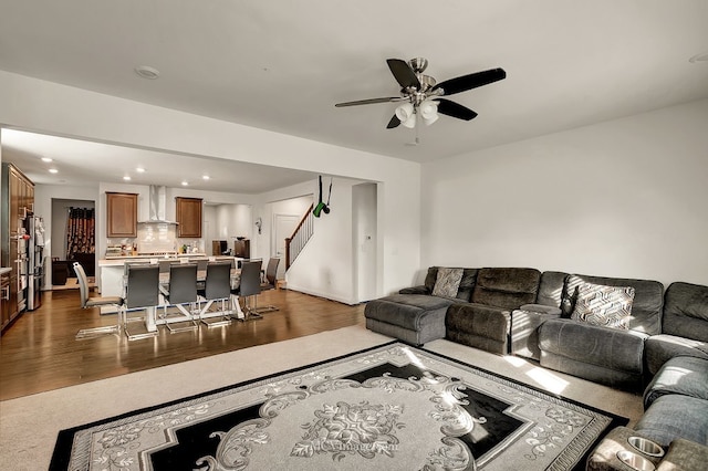 living room with ceiling fan and dark hardwood / wood-style flooring