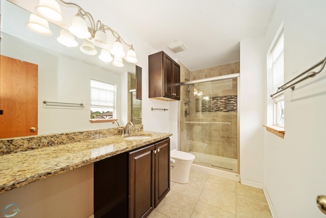 bathroom featuring vanity, tile patterned flooring, a shower with shower door, and toilet