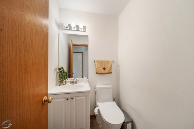 bathroom featuring vanity and toilet