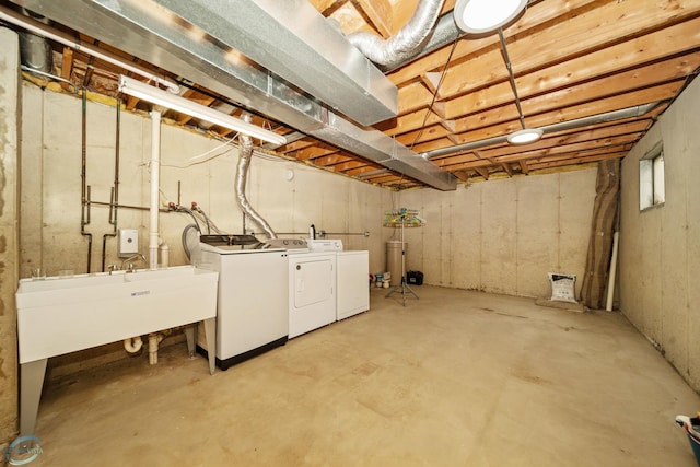 basement with sink and washing machine and clothes dryer