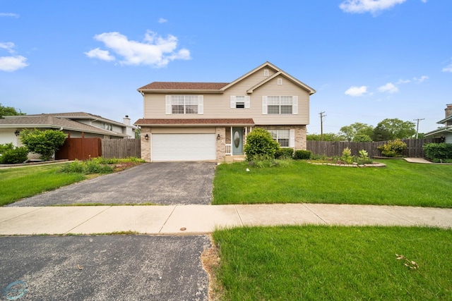 view of front of property with a garage and a front lawn