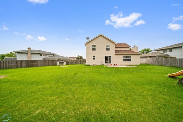 back of property with a patio and a lawn