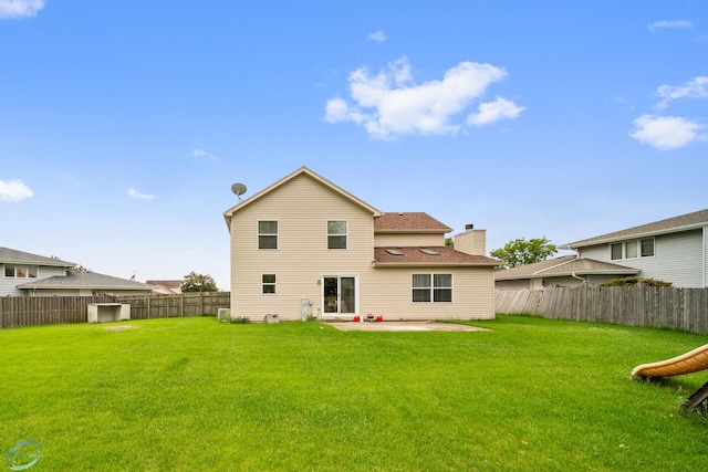 back of property featuring a patio and a lawn