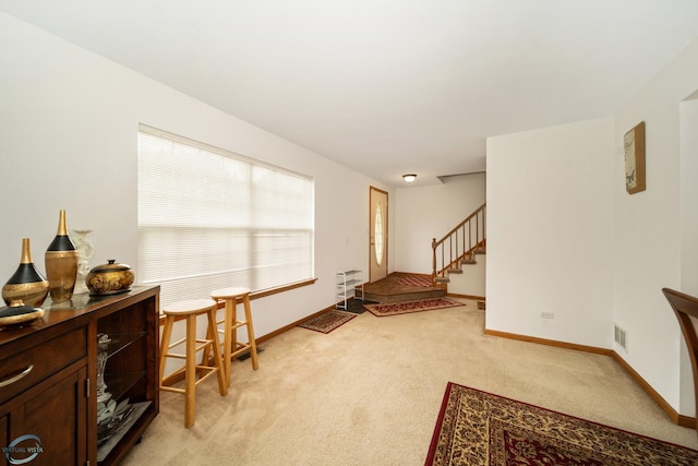 sitting room featuring light carpet