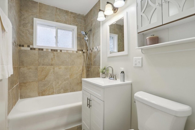 full bathroom with vanity, toilet, and tiled shower / bath