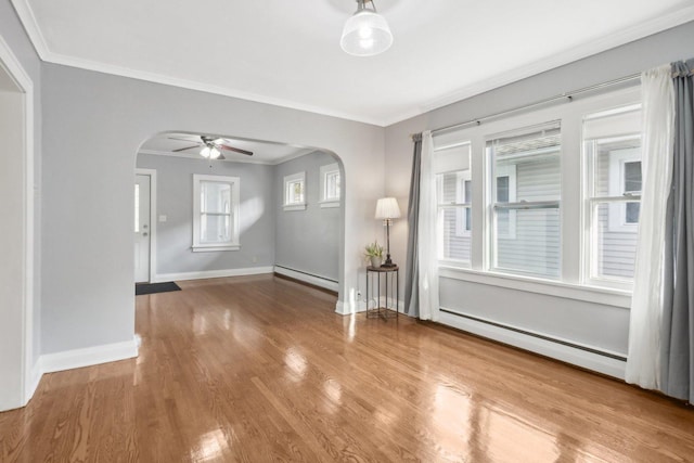 interior space with hardwood / wood-style floors, a baseboard radiator, and ornamental molding