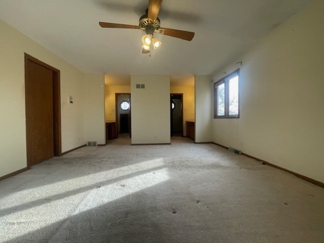 carpeted spare room with ceiling fan