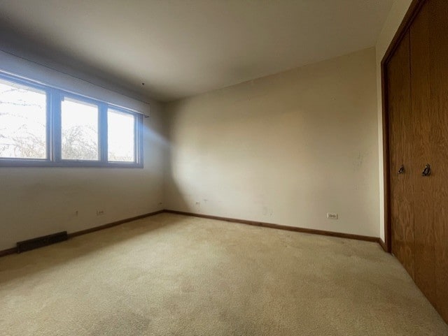 spare room with light colored carpet