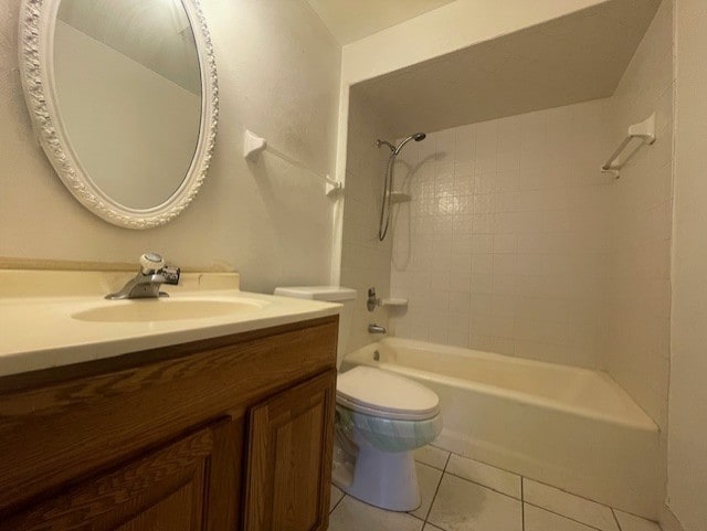 full bathroom with vanity, toilet, tiled shower / bath combo, and tile patterned flooring