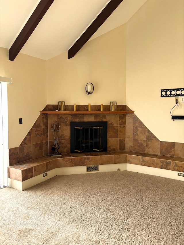 interior space with lofted ceiling with beams, carpet floors, and a fireplace