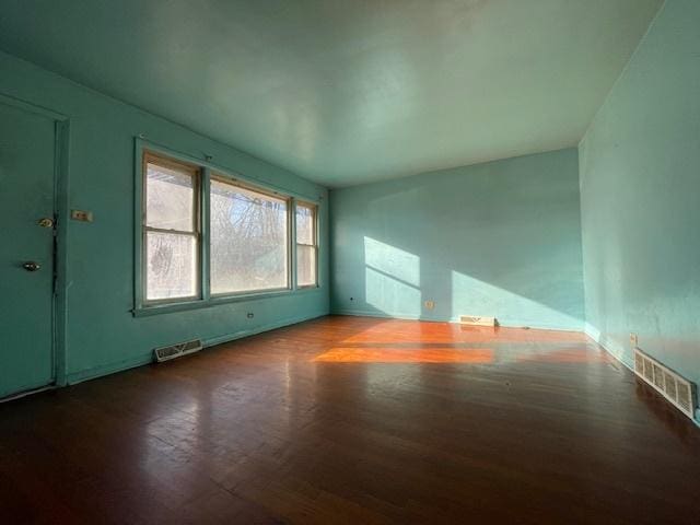 spare room with wood-type flooring